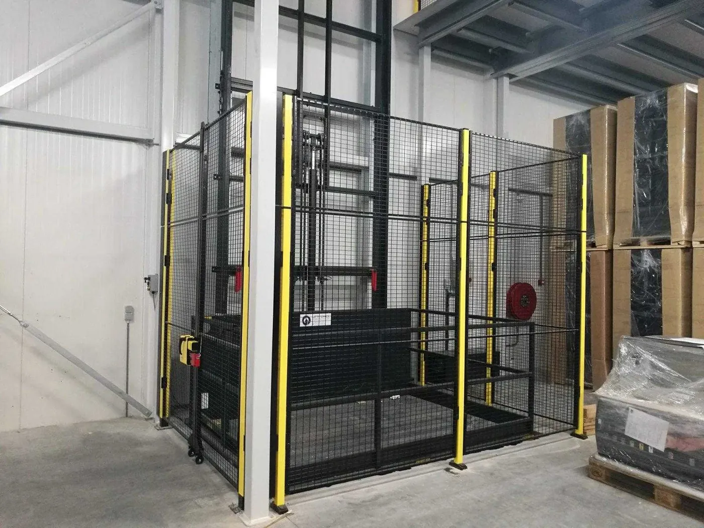 Goederenlift met hekwerk van Liftforce in een magazijn